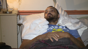 A man laying in bed with his head on the pillow.