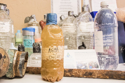 A bottle of water is sitting on the counter.