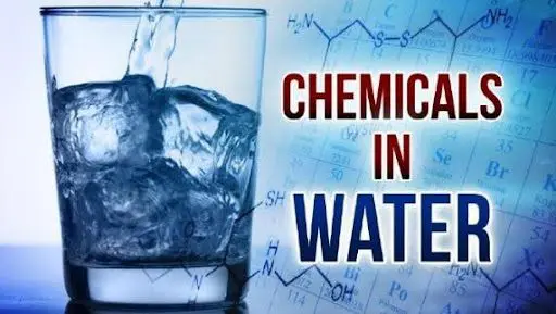 A glass of water with ice and chemical formulas in the background.